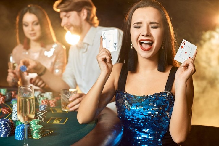 Live dealer at blackjack table with chips and cards visible on the green felt
